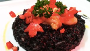 Risotto alle seppie con il suo nero, gamberi rossi e fragole marinate al mojito